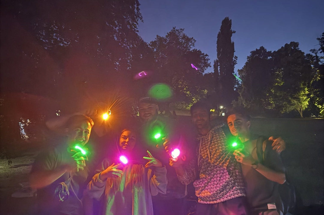 Halloween party ideas with colored phone light: friends at night with green, pink and orange light from phones with FlashyHue color filters